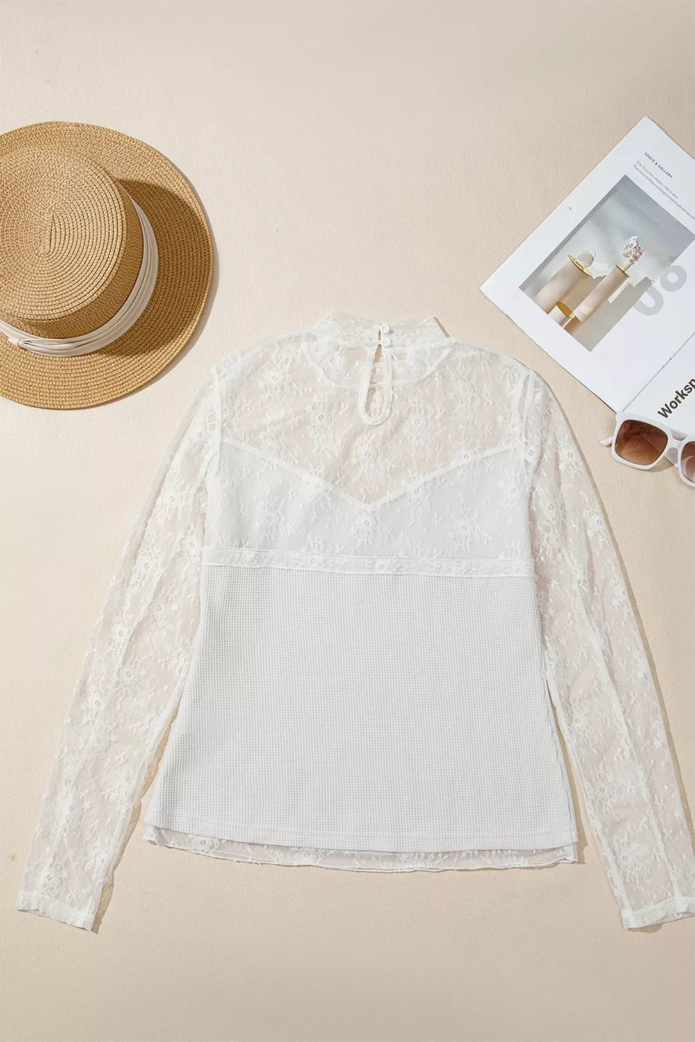 Flat lay of white lace mesh long-sleeve top, back view showing keyhole closure
