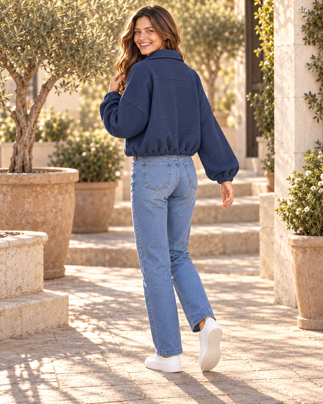 Back view of navy textured jacket showing cinched drawstring hem