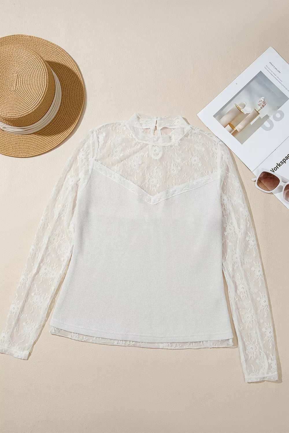 Flat lay of white lace mesh long-sleeve top, front view