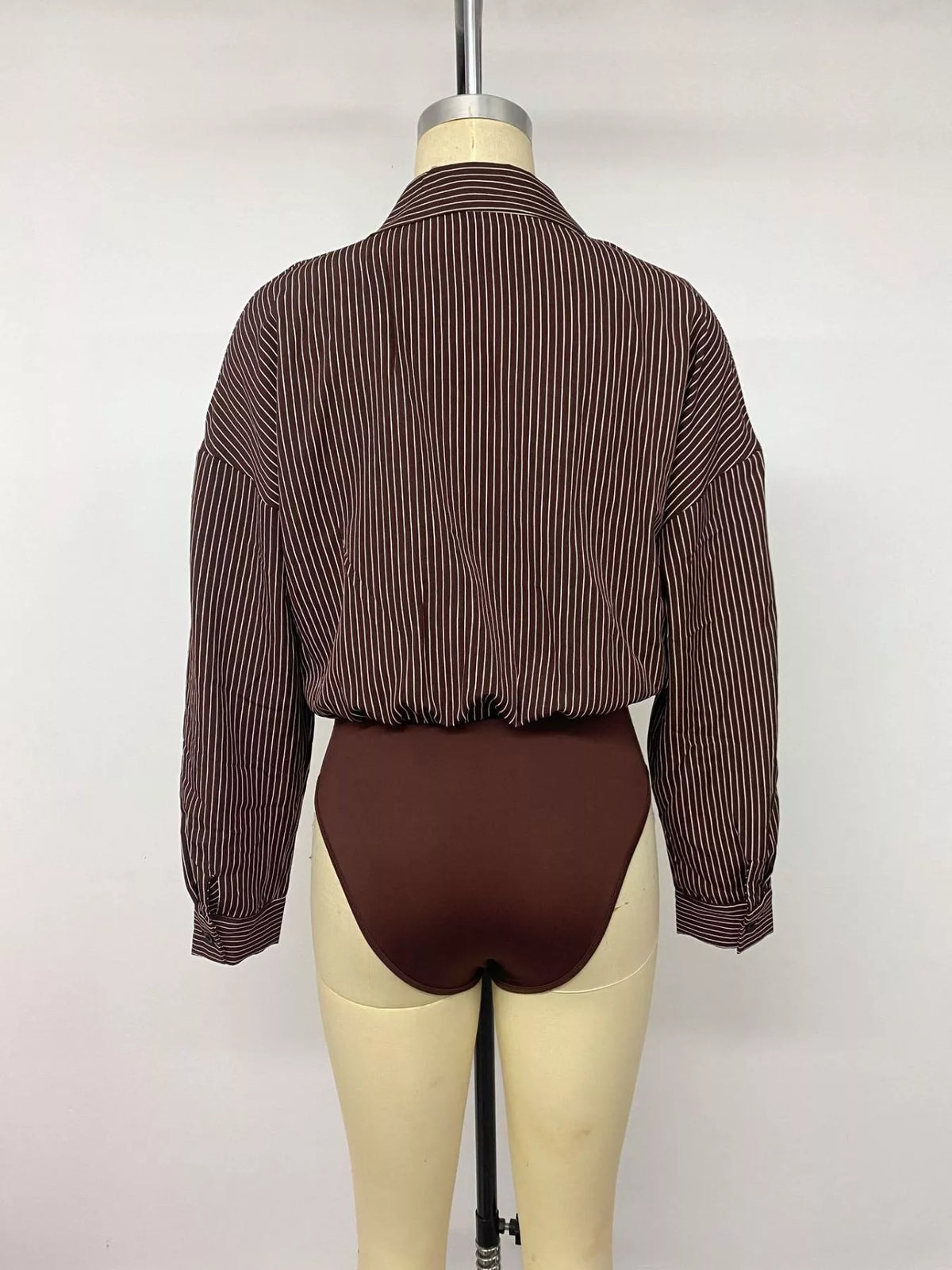 Mannequin back view of brown pinstripe button-up bodysuit